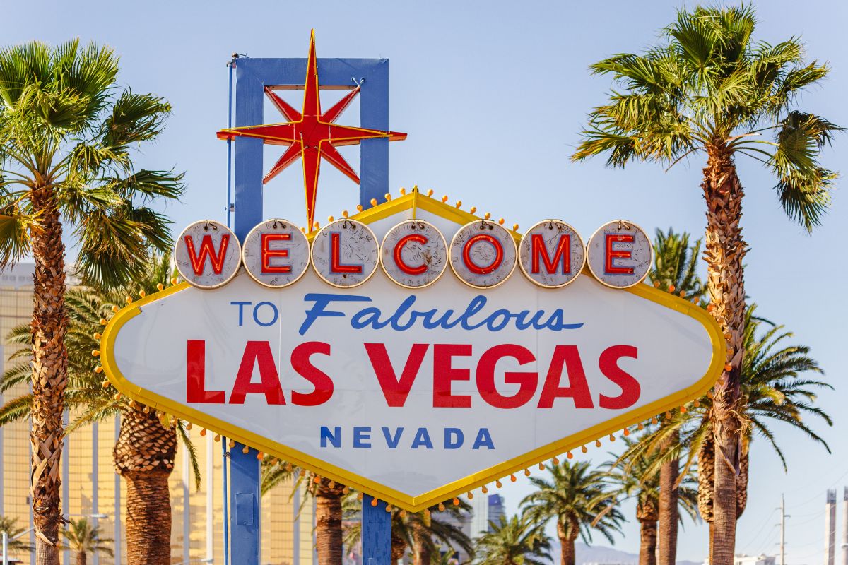 The famous welcome to Las Vegas sign is flanked by palm trees
